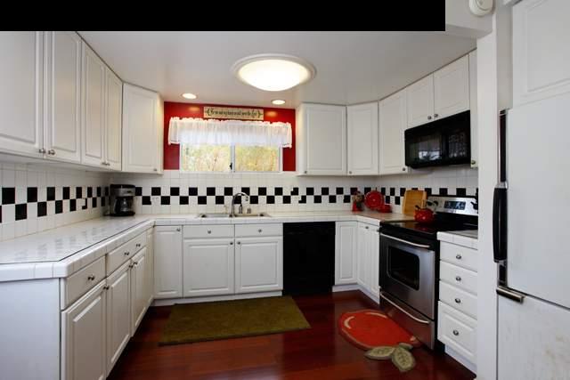 223 Ainakula Road Kula, HI 96790 - Photo 5 of 30 a kitchen with granite countertop a sink a stove and cabinets