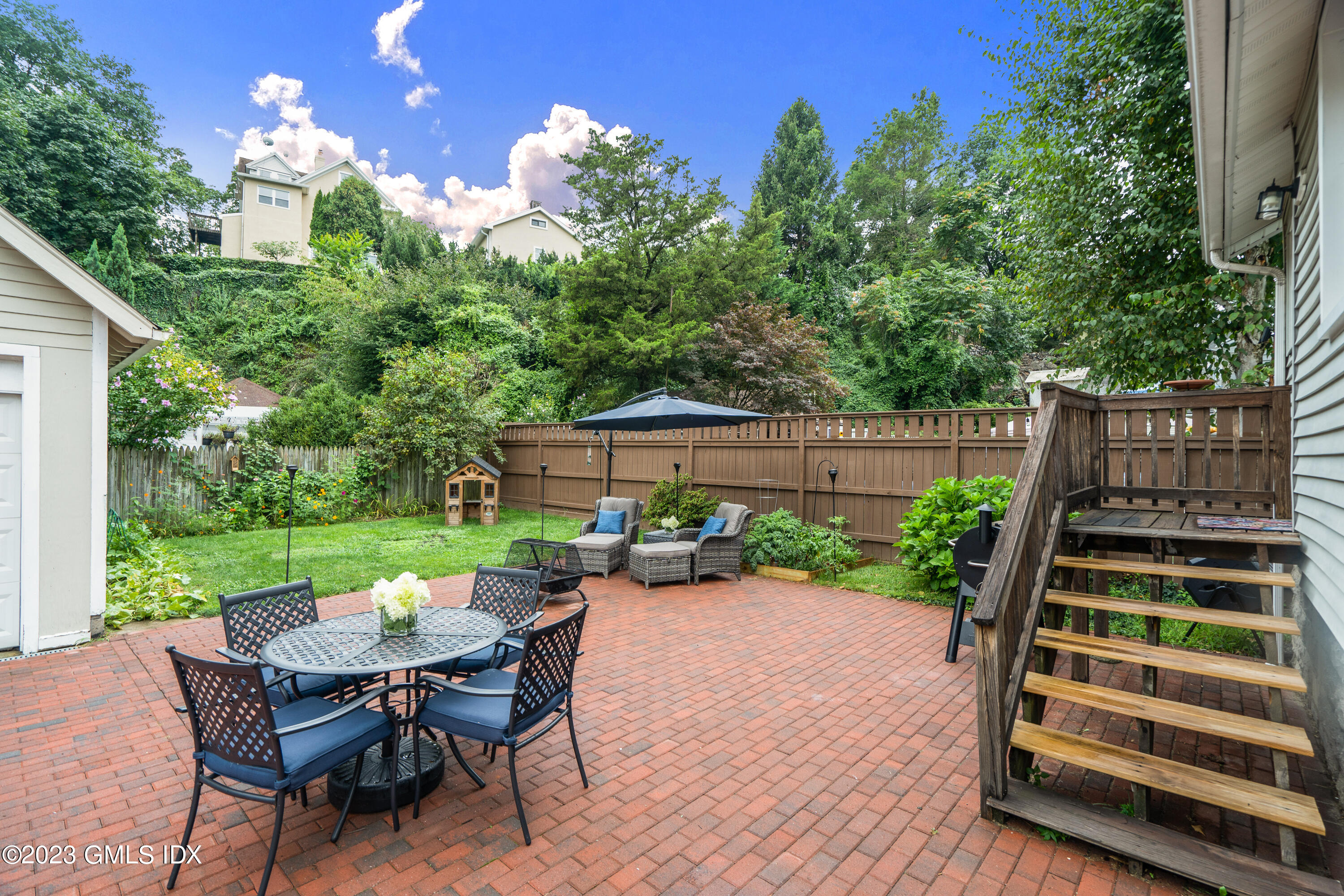 328 Delavan Avenue Greenwich, CT 06830 - Photo 19 of 25 a view of a backyard with sitting area furniture and garden