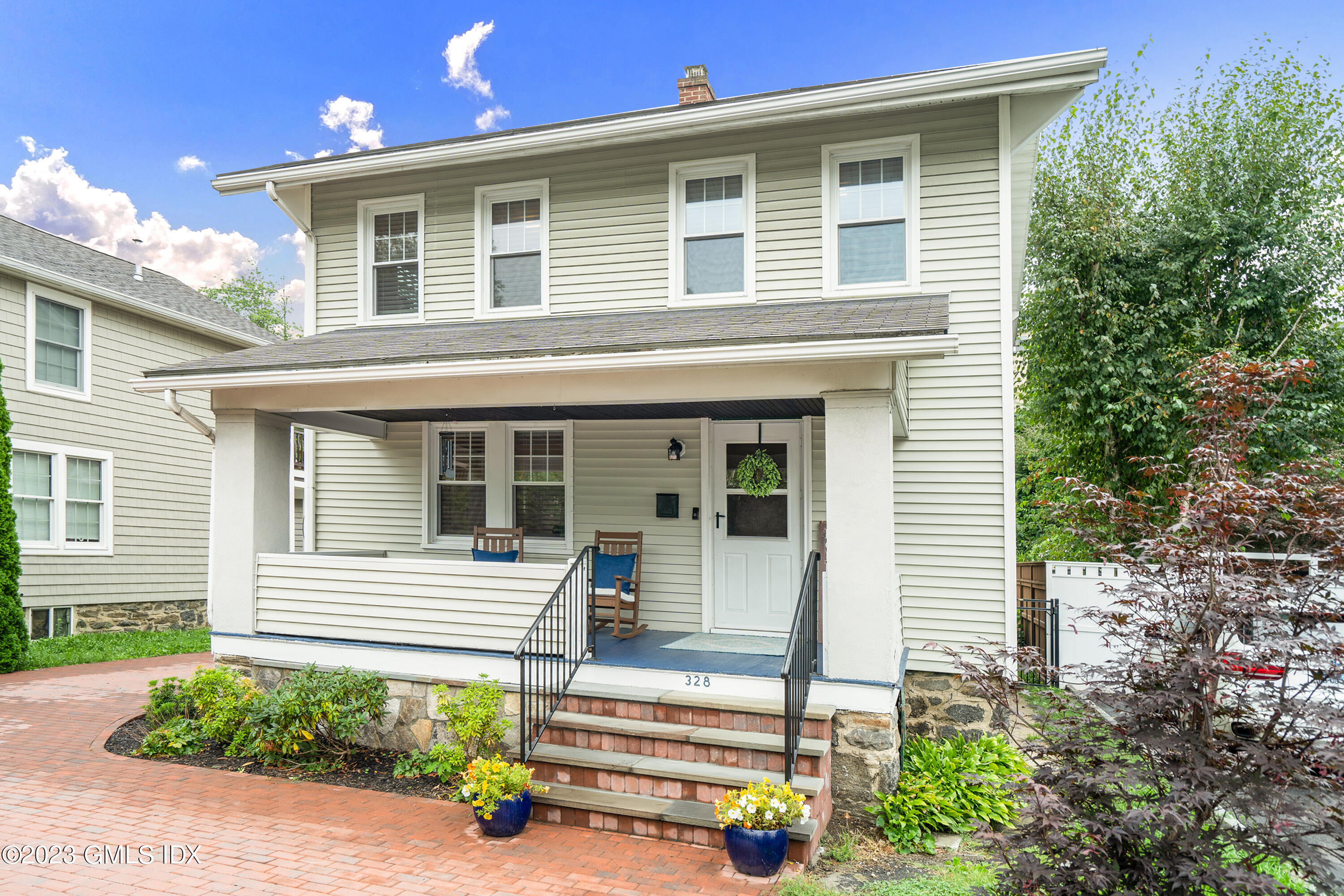 328 Delavan Avenue Greenwich, CT 06830 - Photo 2 of 25 front view of a house with a small yard