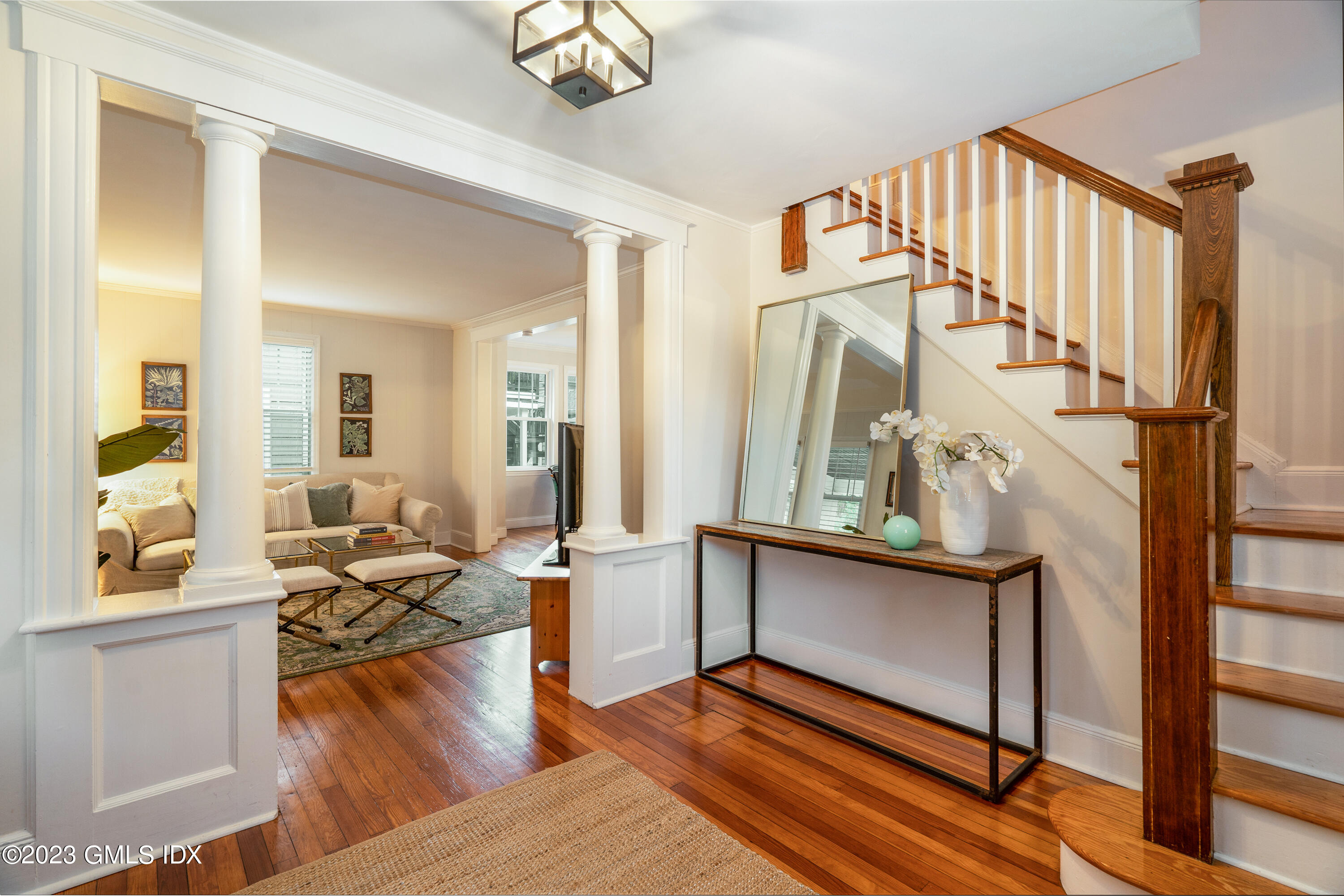 328 Delavan Avenue Greenwich, CT 06830 - Photo 3 of 25 a living room with furniture a wooden floor and a large window