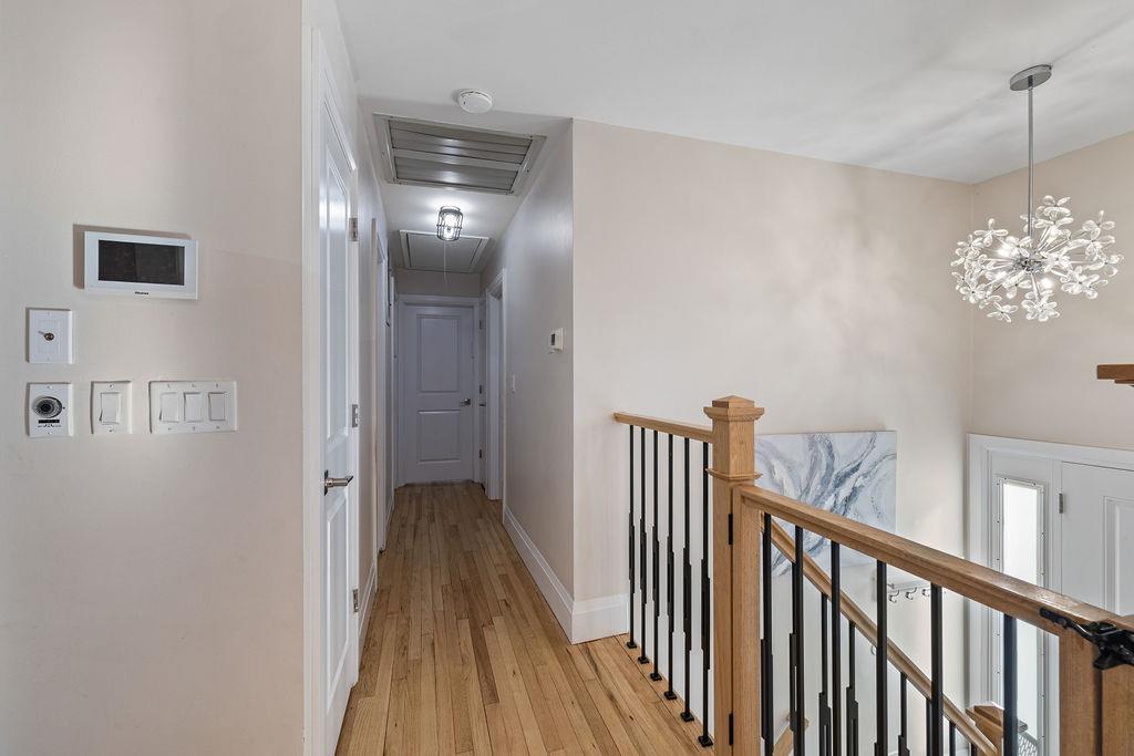 79 Francis Place Spring Valley, NY 10977 - Photo 13 of 37 a view of a hallway with wooden floor and chandelier
