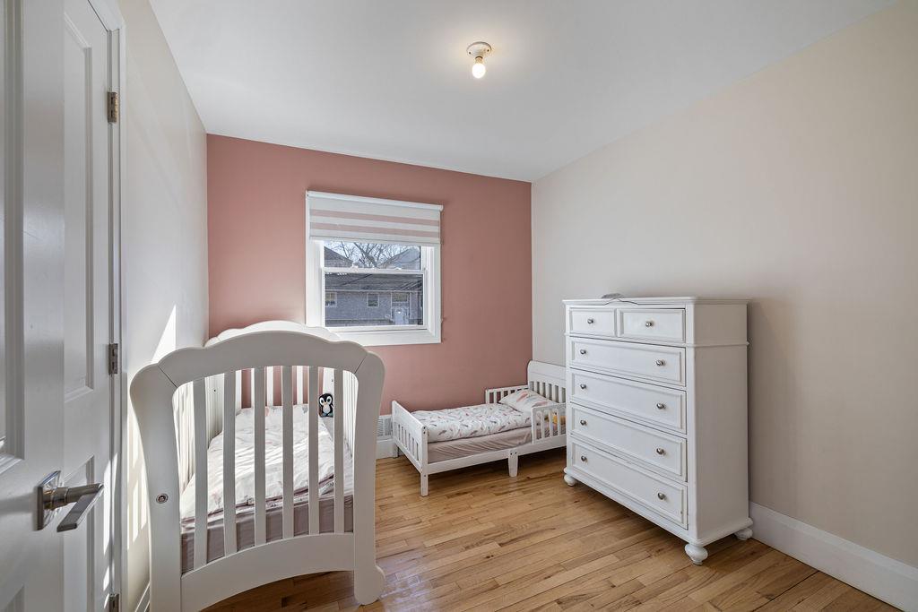 79 Francis Place Spring Valley, NY 10977 - Photo 19 of 37 a bedroom with a baby bed and a window