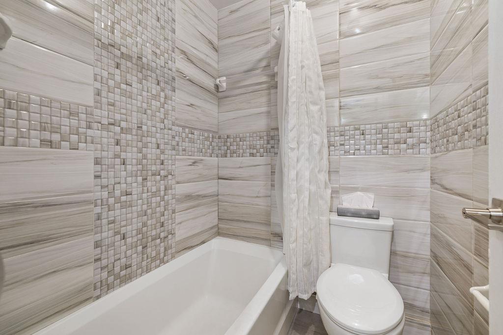 79 Francis Place Spring Valley, NY 10977 - Photo 27 of 37 a bathroom with a toilet and bathtub