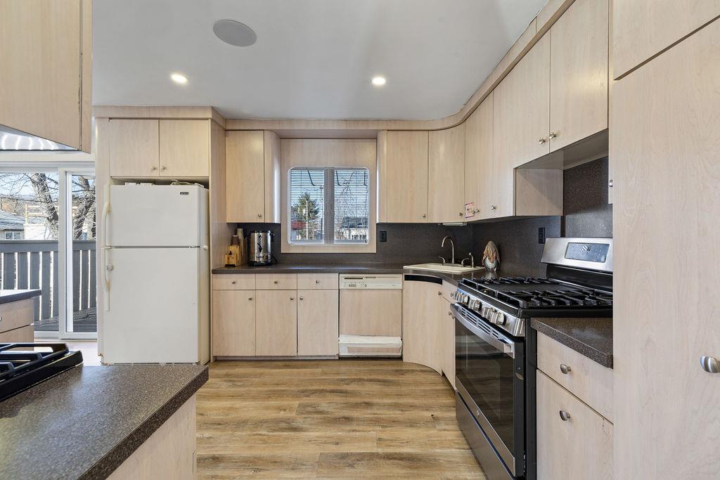 79 Francis Place Spring Valley, NY 10977 - Photo 7 of 37 a kitchen with granite countertop a refrigerator stove top oven and sink
