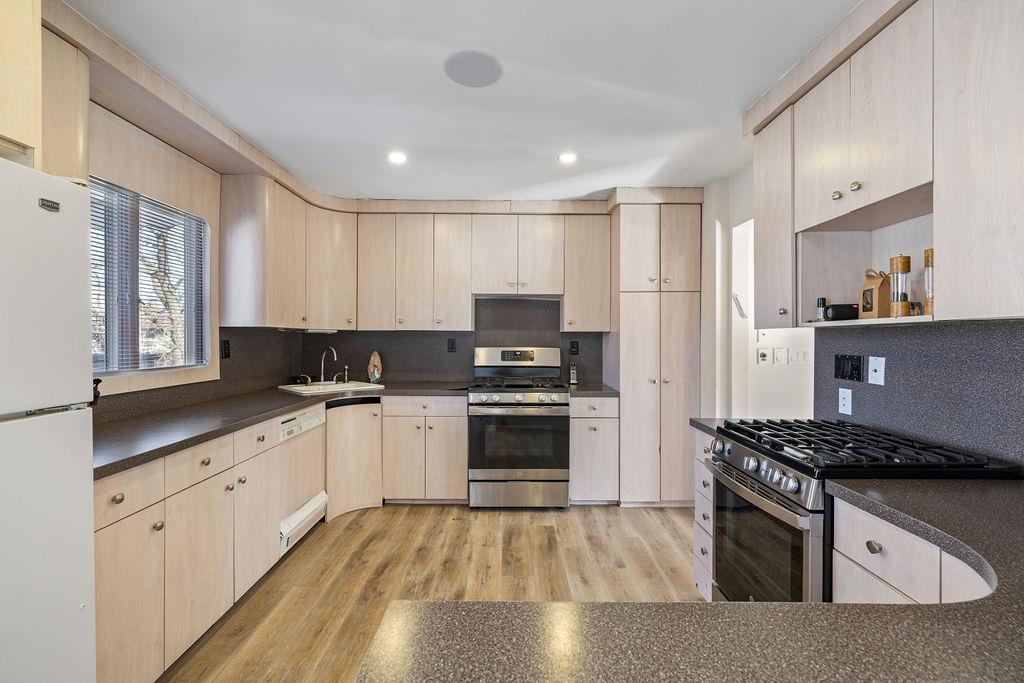 79 Francis Place Spring Valley, NY 10977 - Photo 8 of 37 a kitchen with granite countertop a stove top oven sink and cabinets