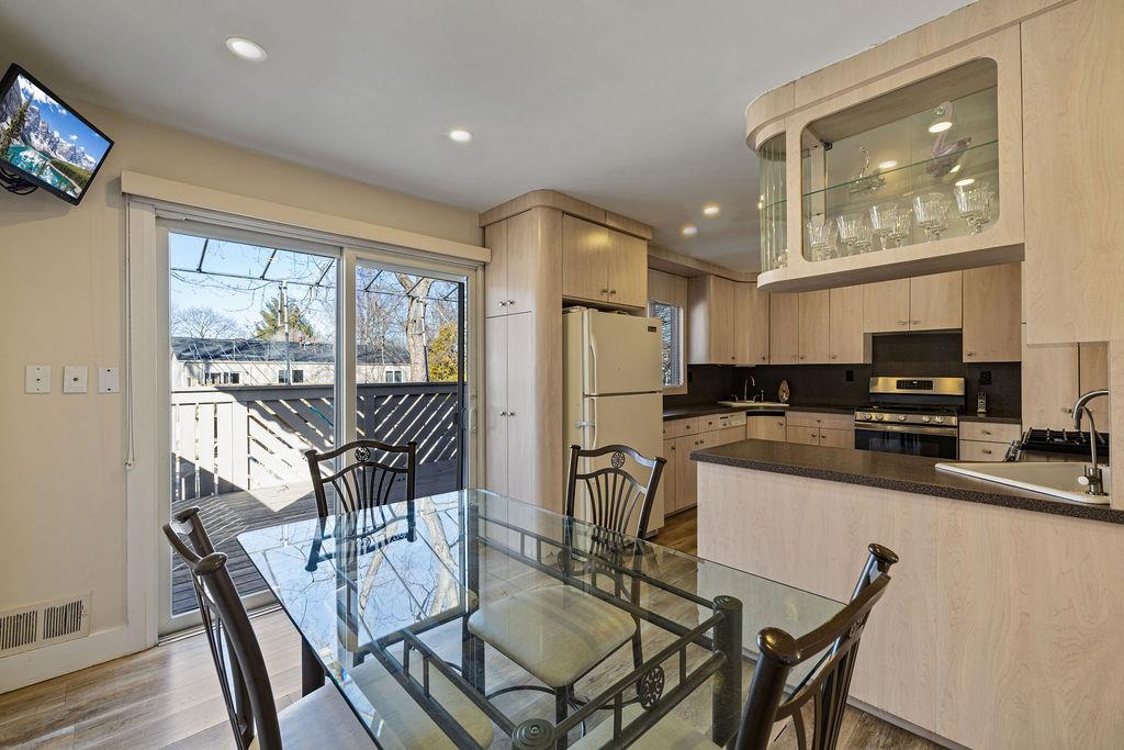79 Francis Place Spring Valley, NY 10977 - Photo 10 of 37 a kitchen with stainless steel appliances granite countertop a stove a refrigerator a kitchen island a table and chairs