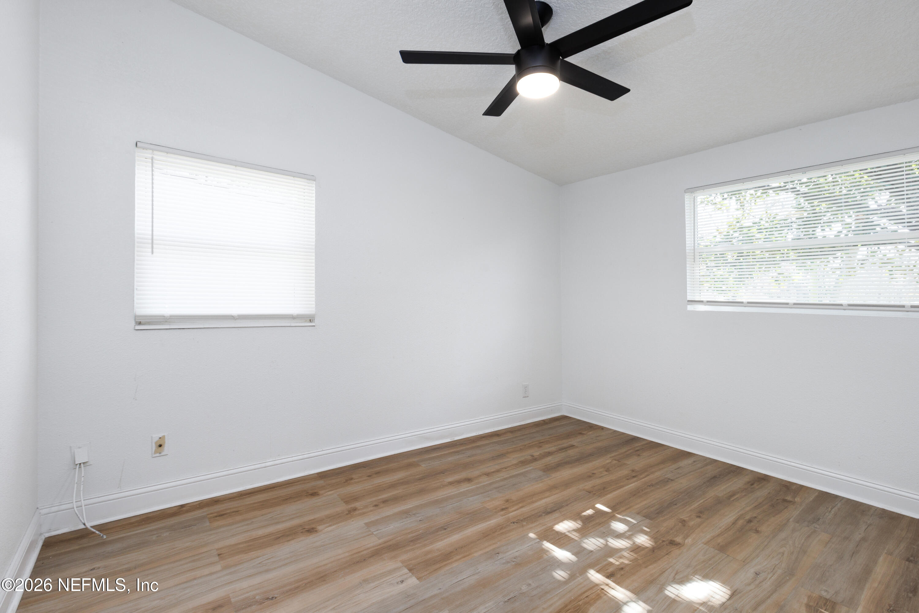 203 Rio Road Jacksonville, FL 32218 - Photo 13 of 24 an empty room with wooden floor and windows