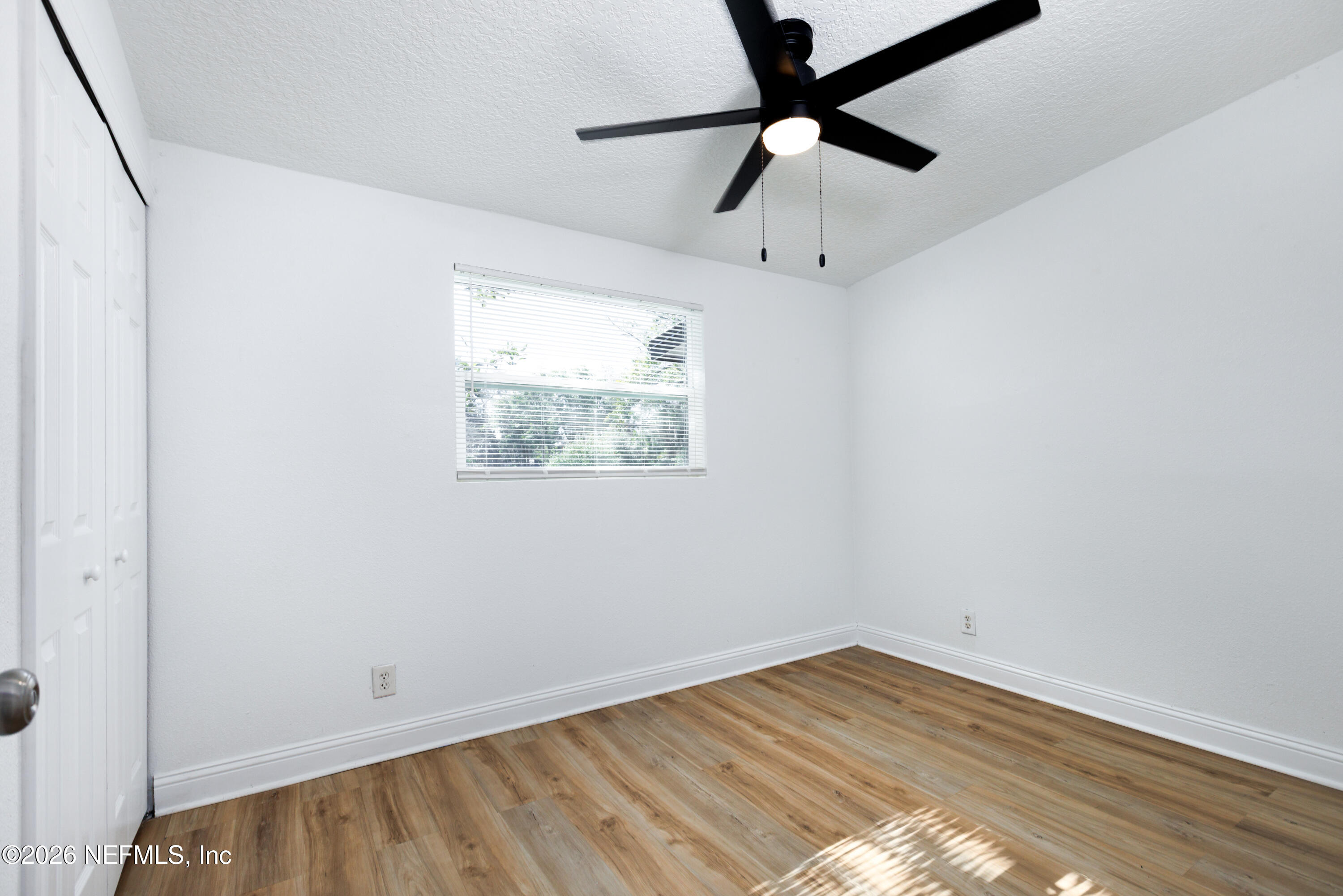 203 Rio Road Jacksonville, FL 32218 - Photo 16 of 27 an empty room with wooden floor and windows