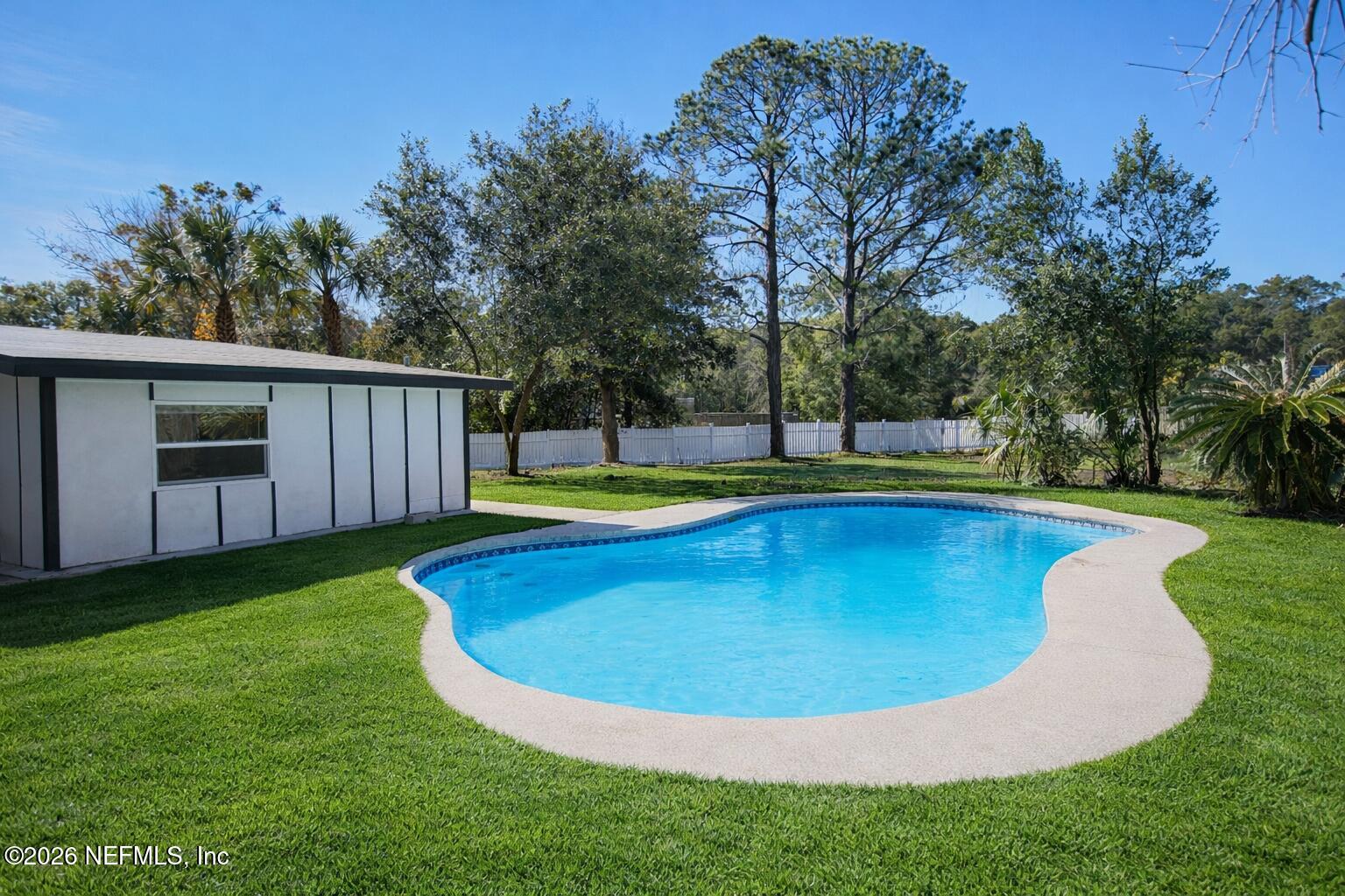 203 Rio Road Jacksonville, FL 32218 - Photo 2 of 27 a view of a swimming pool with an outdoor space and seating area