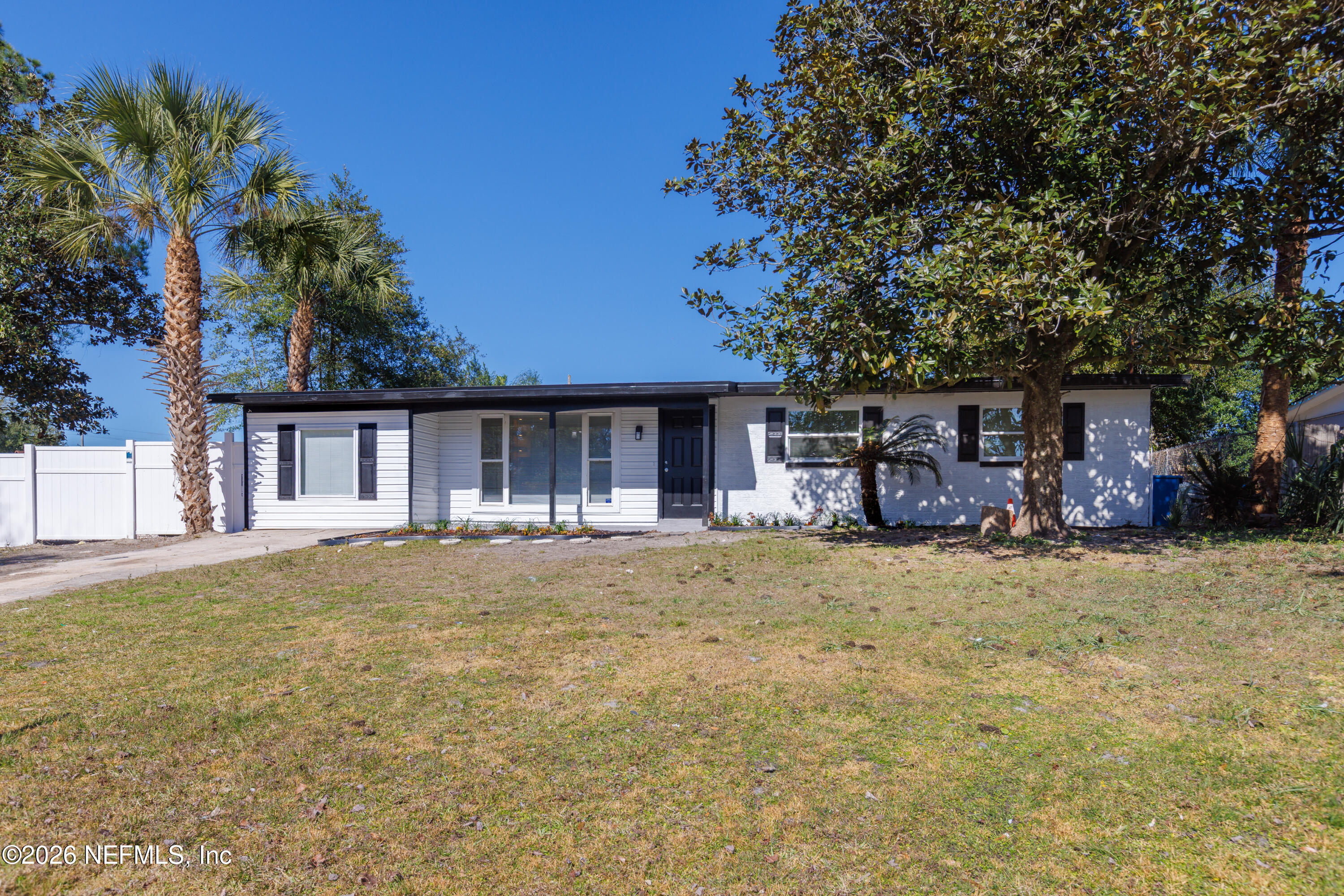 203 Rio Road Jacksonville, FL 32218 - Photo 24 of 27 a front view of a house with a garden and patio