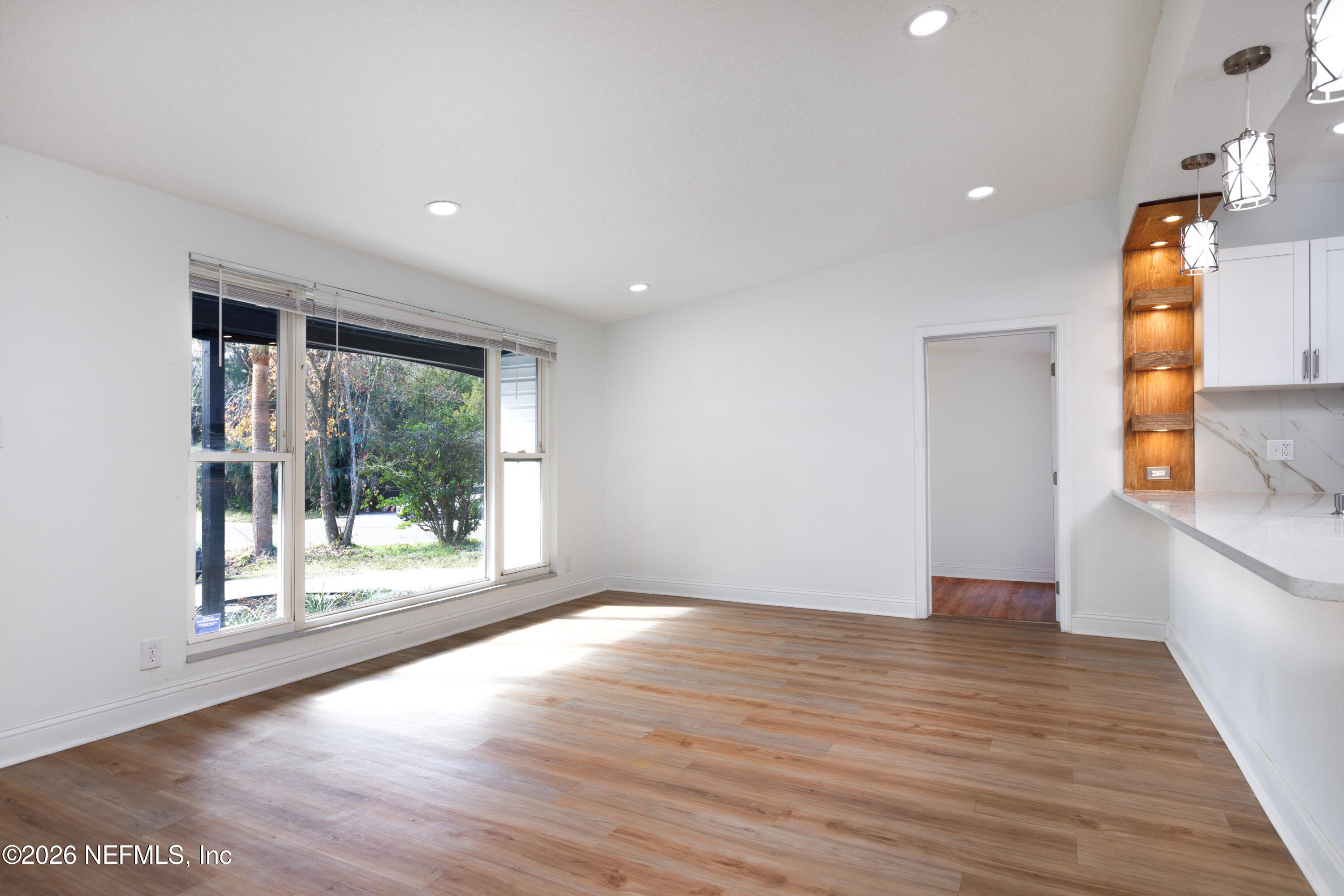 203 Rio Road Jacksonville, FL 32218 - Photo 4 of 27 a view of empty room with wooden floor and fan