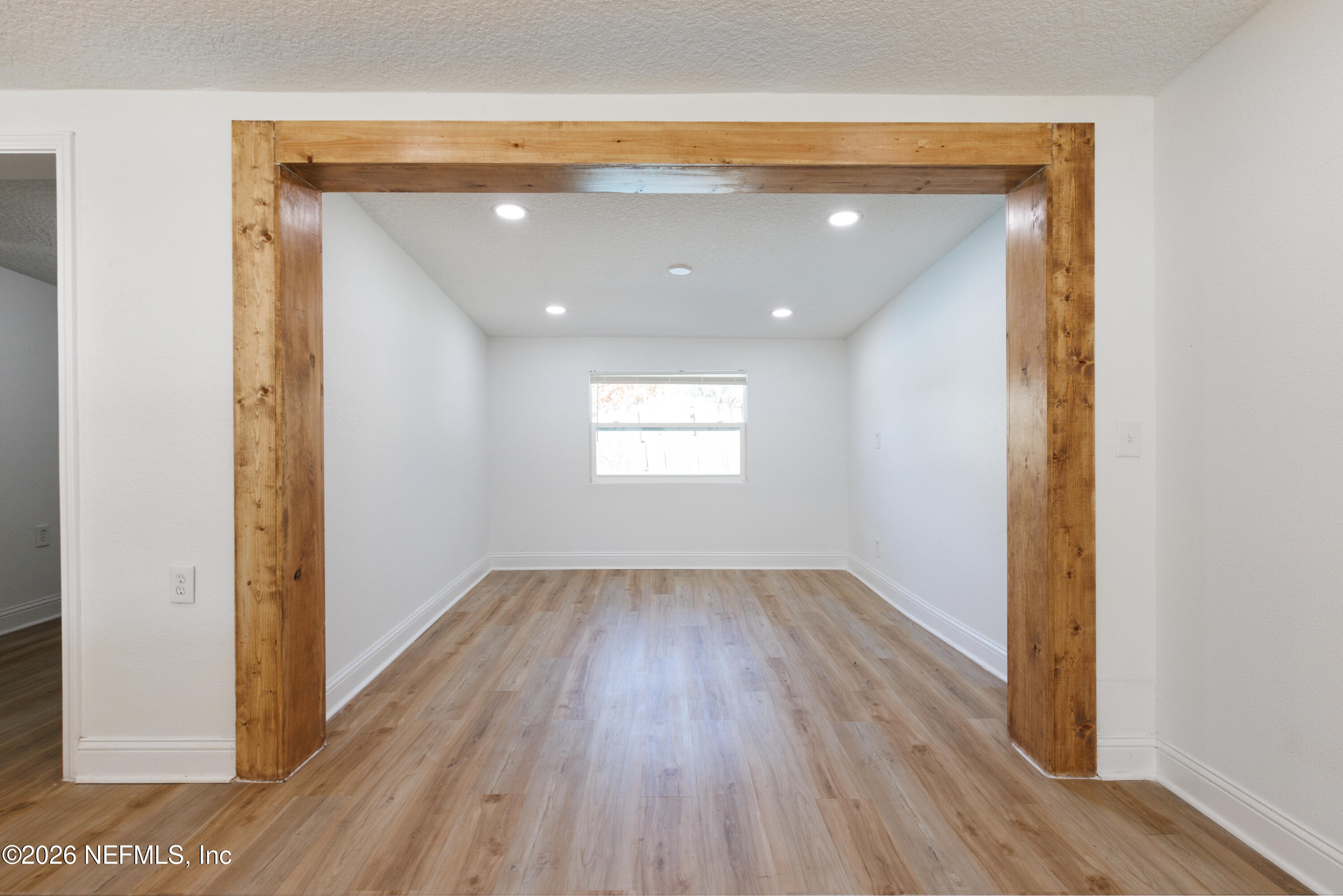 203 Rio Road Jacksonville, FL 32218 - Photo 8 of 24 a view of empty room with wooden floor and fan