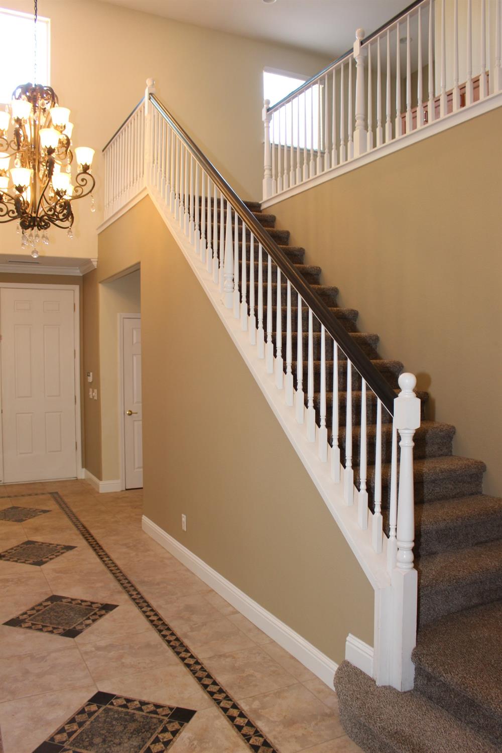 2478 Rall Avenue Clovis, CA 93611 - Photo 14 of 35 a view of staircase with railing and a chandelier