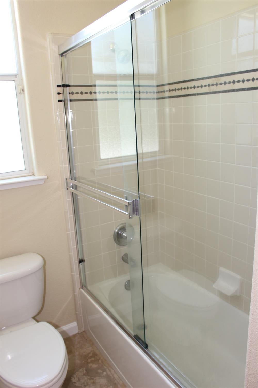 2478 Rall Avenue Clovis, CA 93611 - Photo 18 of 35 a bathroom with a toilet and a shower