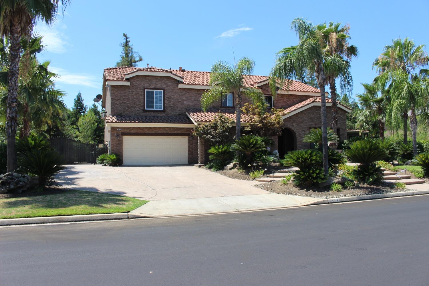 2478 Rall Avenue Clovis, CA 93611 - Photo 2 of 35 a front view of a house with a yard and garage