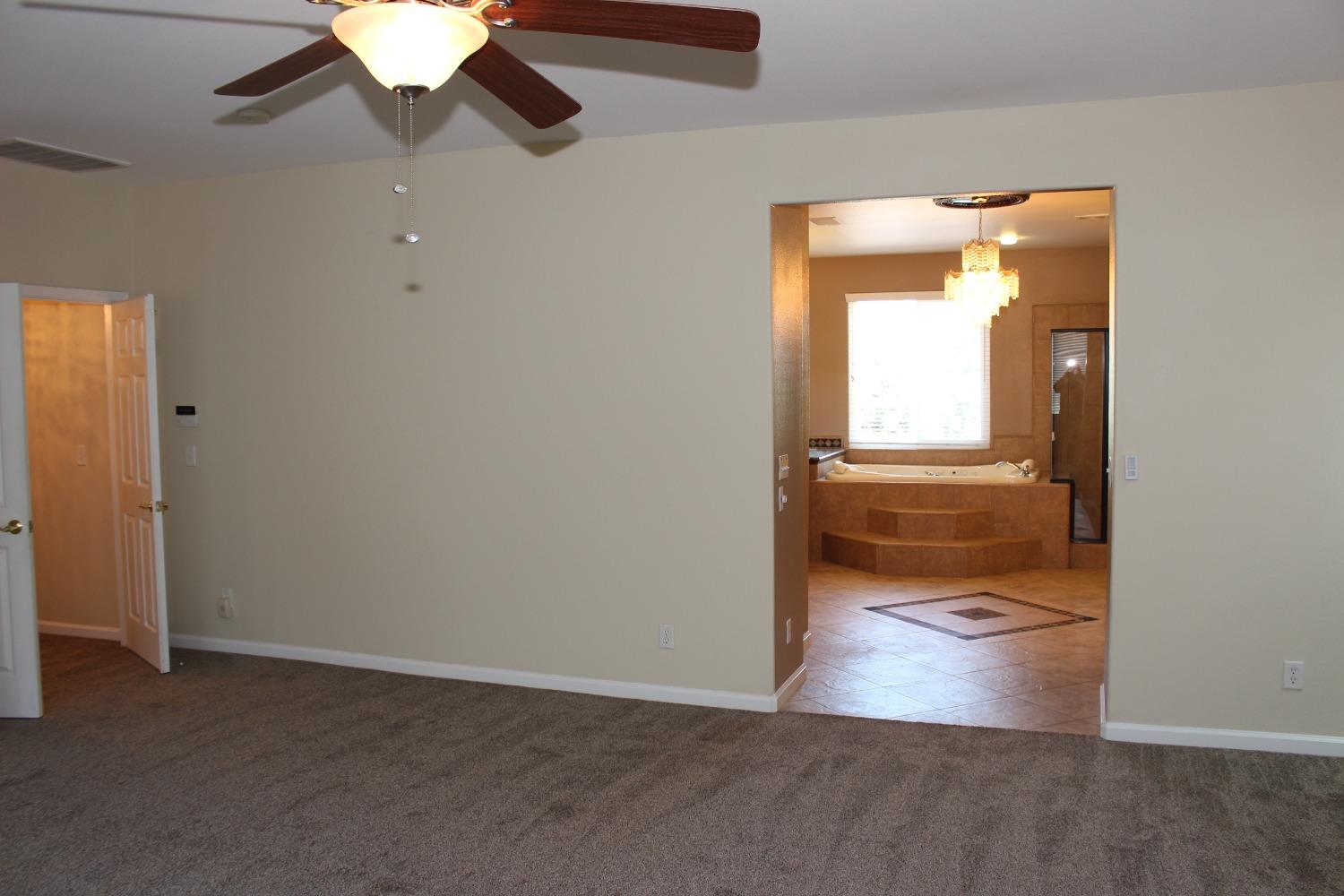 2478 Rall Avenue Clovis, CA 93611 - Photo 22 of 35 an empty room with wooden floor and windows