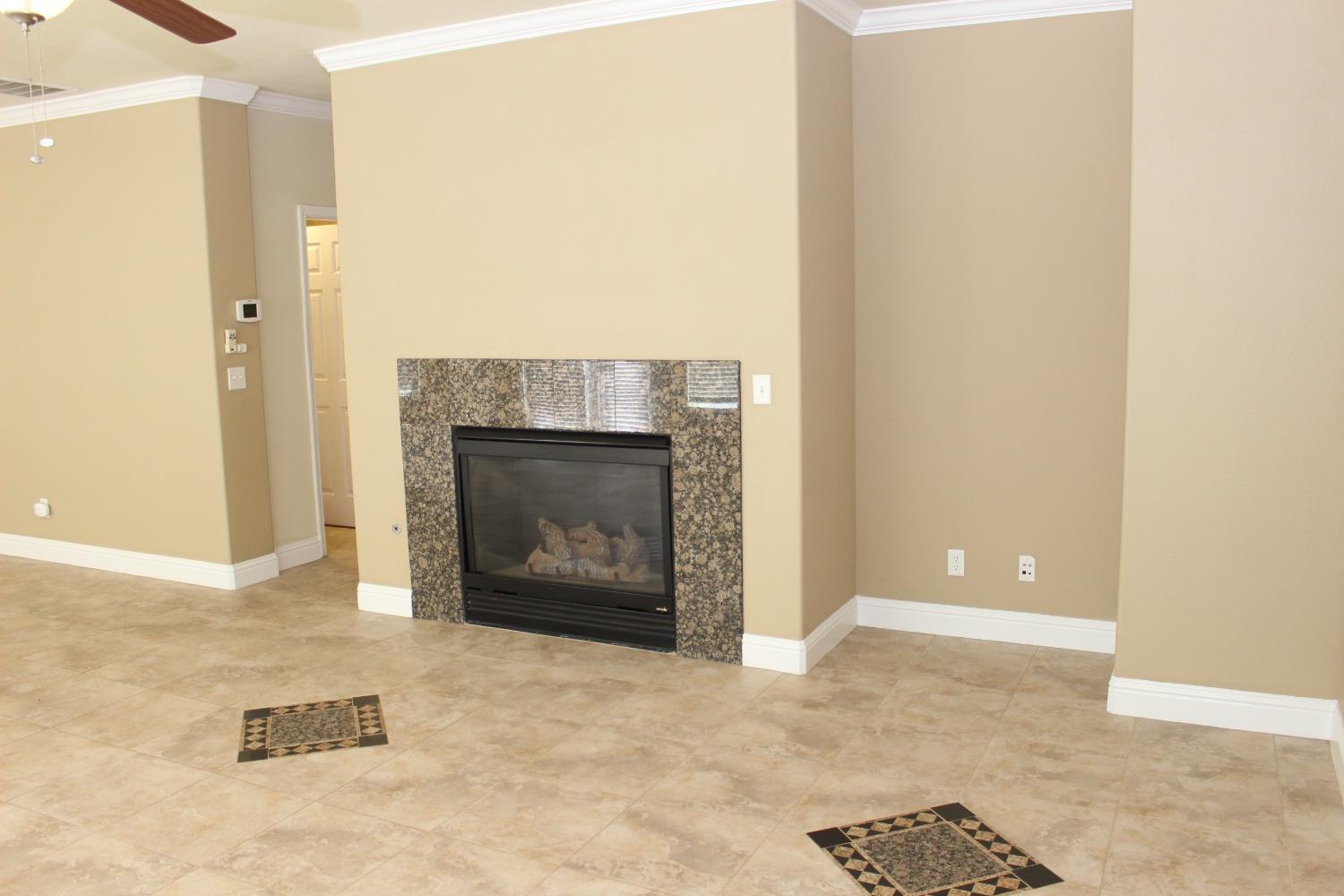 2478 Rall Avenue Clovis, CA 93611 - Photo 9 of 35 a view of an empty room with a fireplace