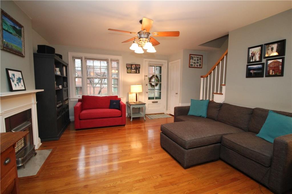 542 Bigham Road Pittsburgh, PA 15211 - Photo 5 of 25 The living room as seen from the dining room showing the picture window looking out into the courtyard. There is a large coat closet adjacent to the front door.