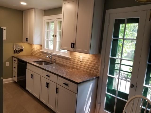 542 Bigham Road Pittsburgh, PA 15211 - Photo 10 of 25 The kitchen has been updated with white shaker cabinets, under cabinet lighting, white beveled subway tile, and quartz counters.
