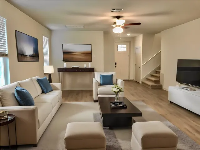 a living room with furniture and a flat screen tv