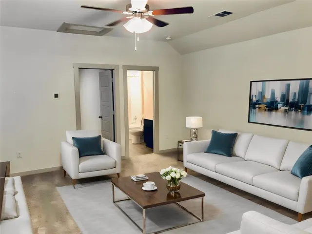 a living room with furniture and a chandelier