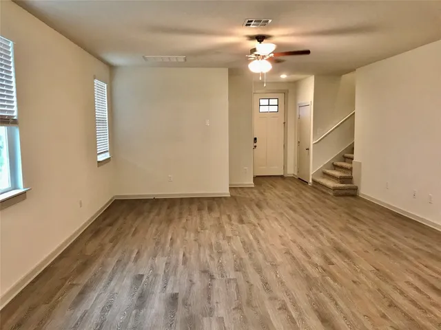 wooden floor in an empty room with a window