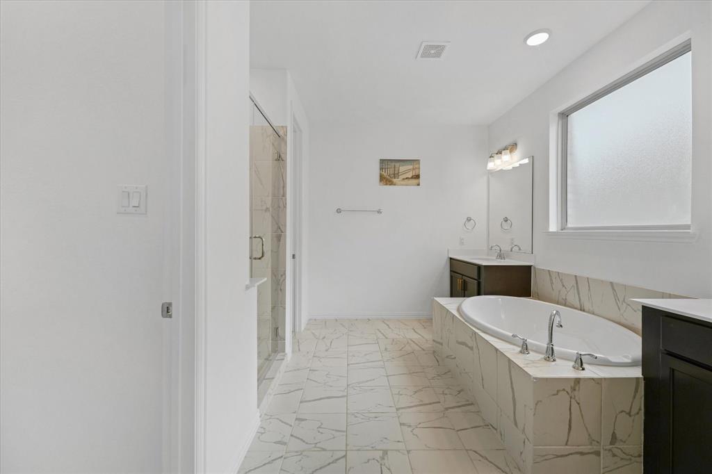 3533 Hyacinth Way Prosper, TX 75078 - Photo 18 of 38 a bathroom with a tub shower and mirror