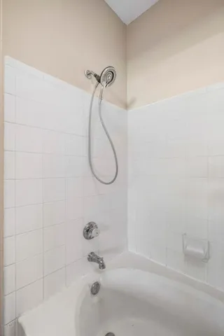 a bathroom with a bath tub with a shower