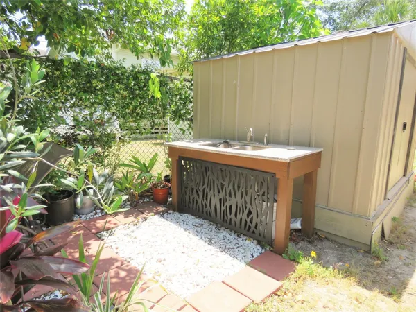 a backyard of a house with a yard and outdoor seating