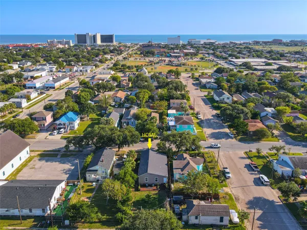 an aerial view of residential houses with city view