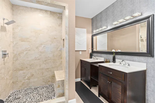 a bathroom with a sink a mirror and a shower