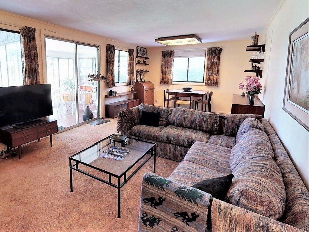63 Lakeshore Road Natick, MA 01760 - Photo 12 of 30 a living room with furniture and a flat screen tv