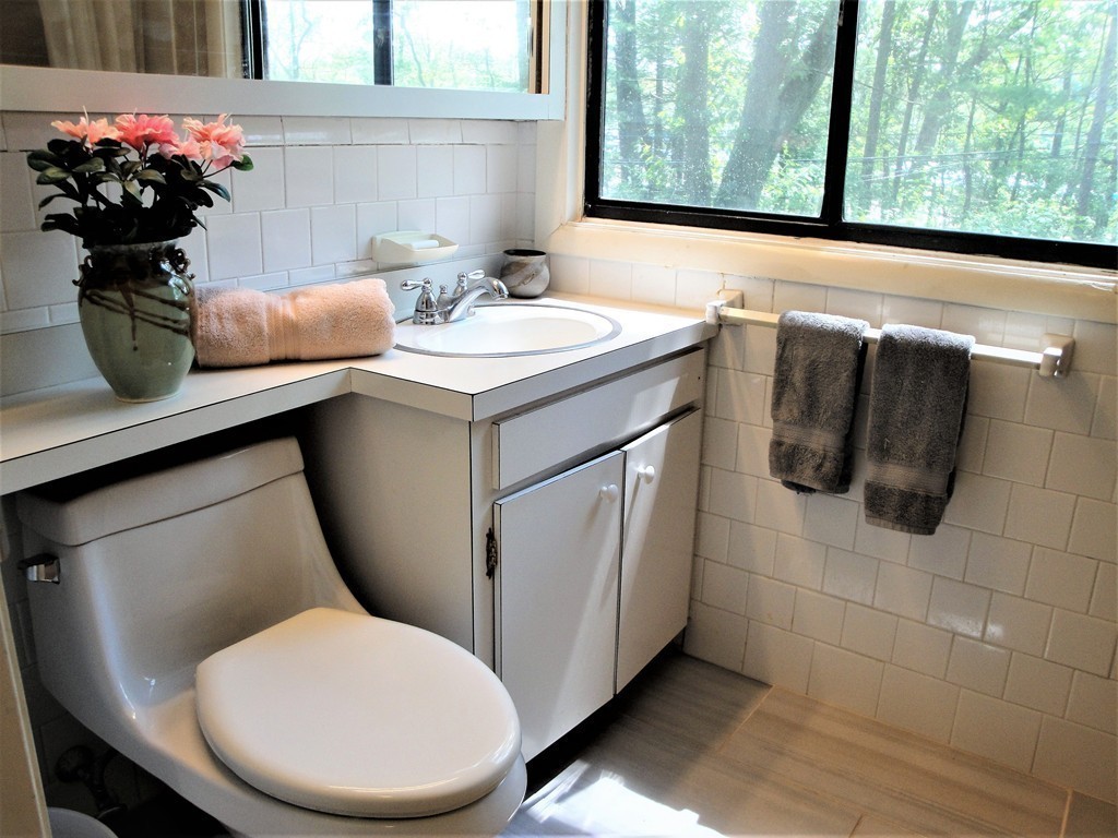 63 Lakeshore Road Natick, MA 01760 - Photo 22 of 30 a bathroom with a toilet sink and mirror