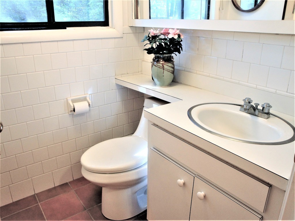 63 Lakeshore Road Natick, MA 01760 - Photo 24 of 30 a bathroom with a sink toilet and a mirror