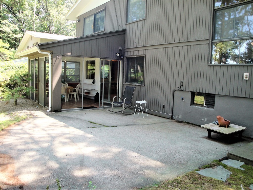 63 Lakeshore Road Natick, MA 01760 - Photo 27 of 30 a backyard of a house with yard and seating space