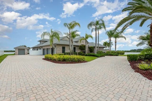 a front view of multi story residential apartment building with yard