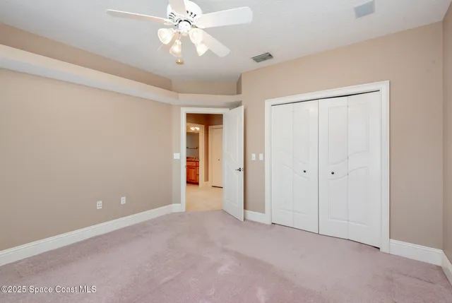 a view of a porch with chairs and backyard of the house