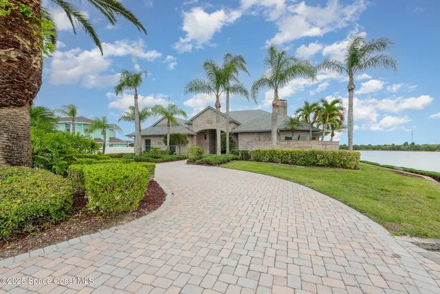 a view of a white house with a yard