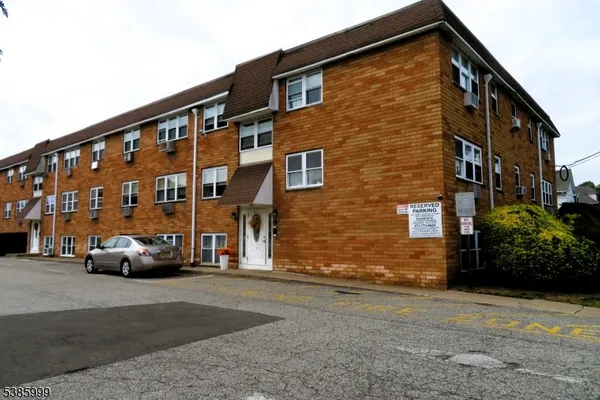 a view of building with car parked