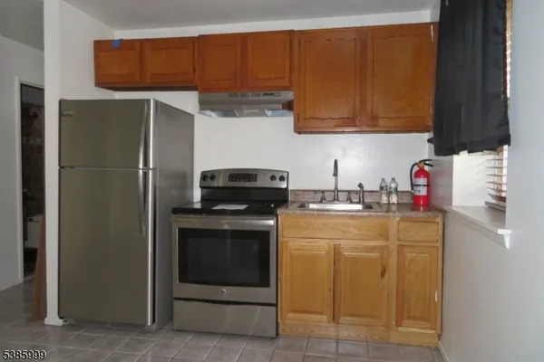 a kitchen with a sink and a refrigerator
