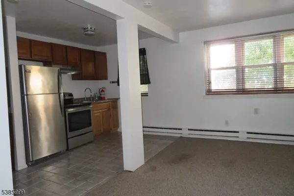 a kitchen with stainless steel appliances a refrigerator and a stove top oven