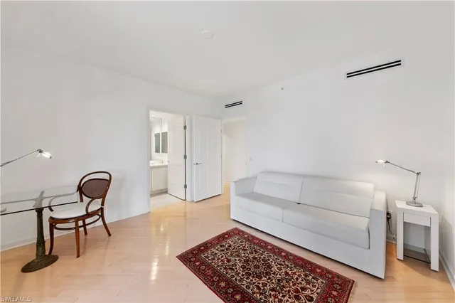 a room with a chair and white walls