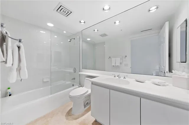 a bathroom with a bathtub shower sink and toilet