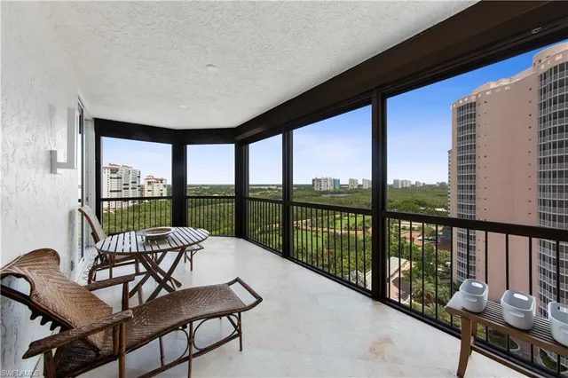 a balcony with furniture and view of lake