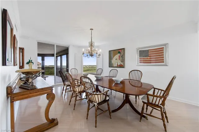 a view of a dining room with furniture and chandelier