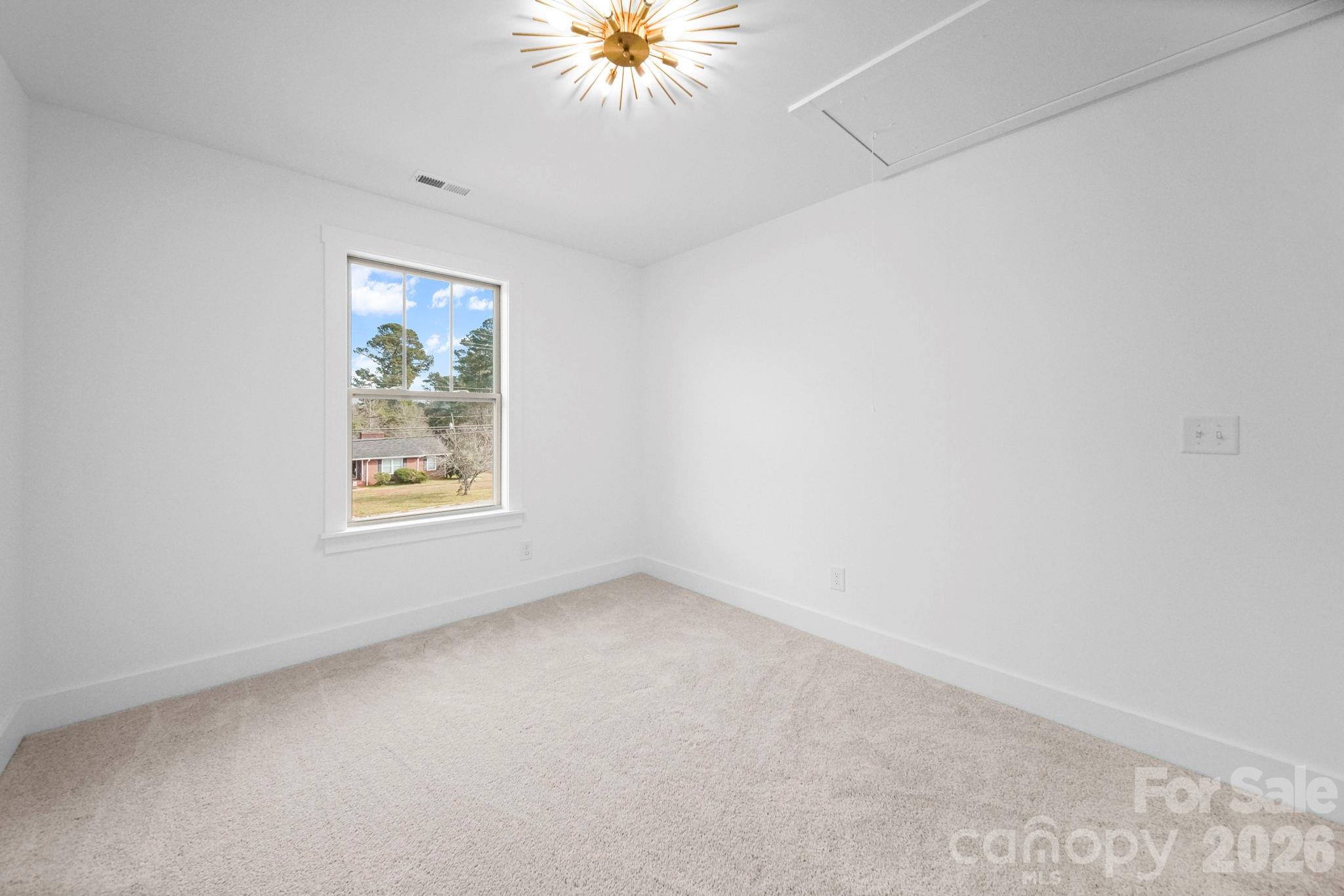 1220 Morven Road Wadesboro, NC 28170 - Photo 12 of 17 an empty room with a window
