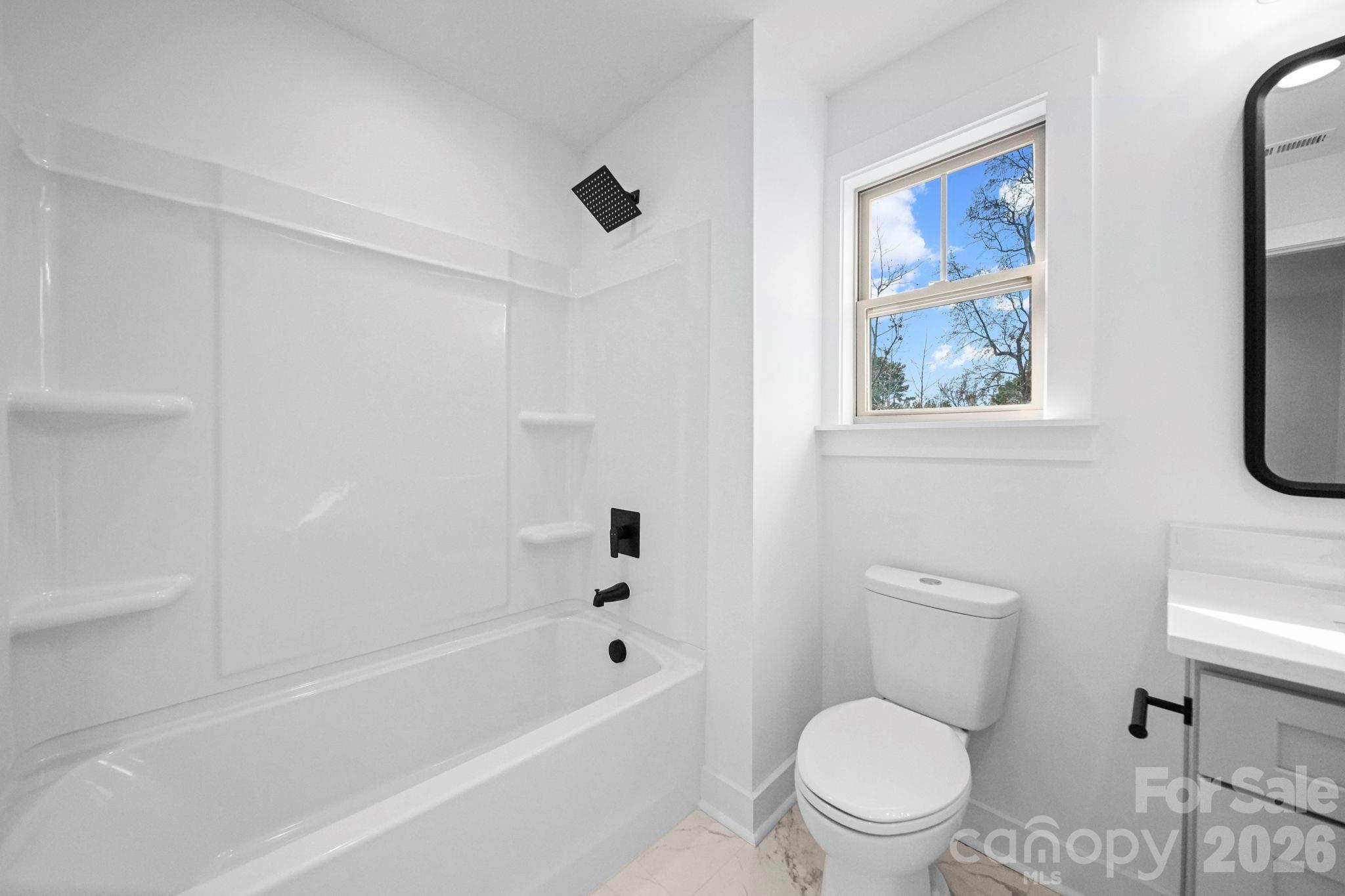 1220 Morven Road Wadesboro, NC 28170 - Photo 13 of 17 a white toilet sitting next to a bath tub