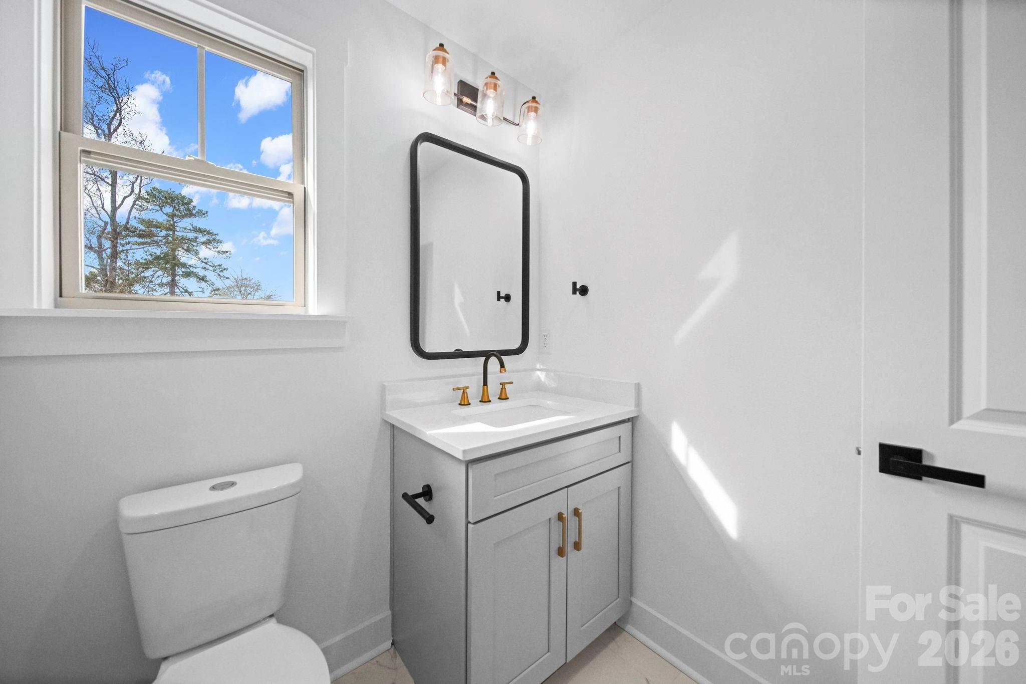 1220 Morven Road Wadesboro, NC 28170 - Photo 14 of 17 a bathroom with a toilet sink and mirror