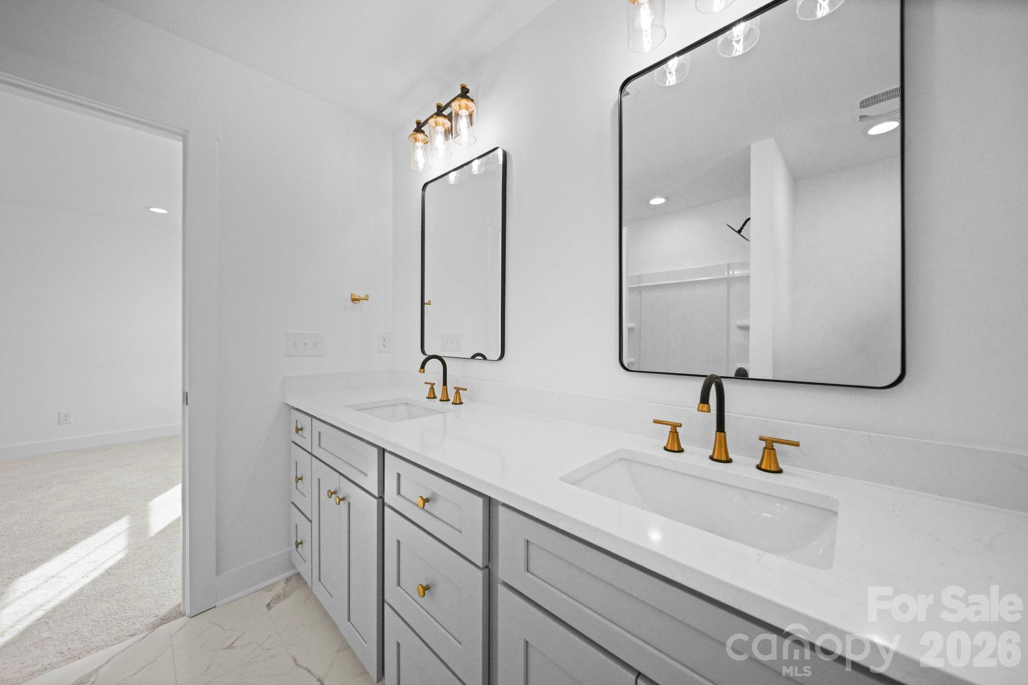 1220 Morven Road Wadesboro, NC 28170 - Photo 16 of 17 a bathroom with double vanity sink and a mirror