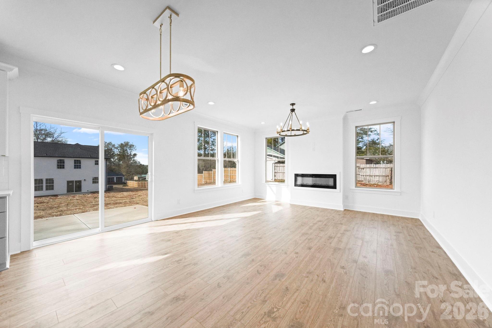 1220 Morven Road Wadesboro, NC 28170 - Photo 6 of 17 a view of an empty room with a window and wooden floor